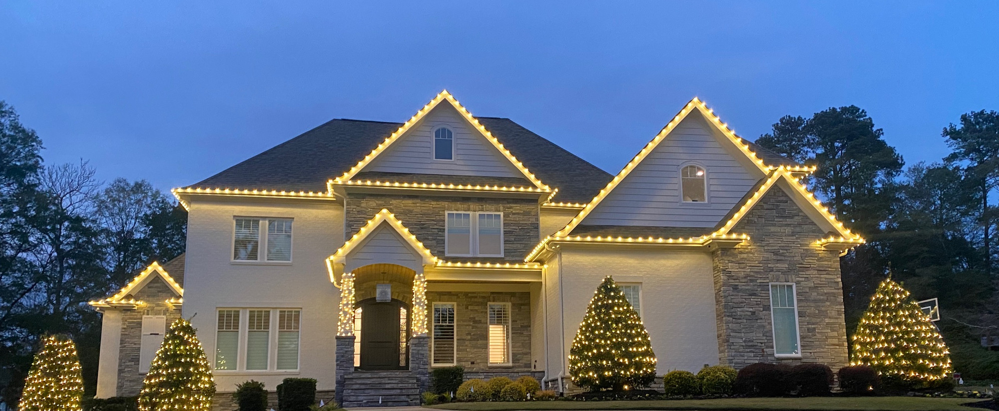 Warm white Christmas lighting on a home